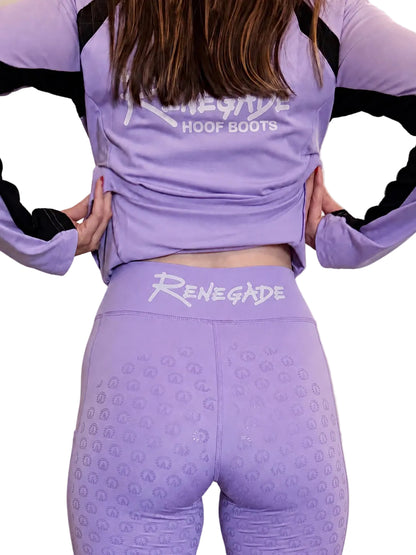 A model from behind wearing a lavender purple Renegade Hoof Boots athletic set, featuring a long-sleeve top with black sleeve accents and matching high-waisted leggings with a white logo on the waistband.